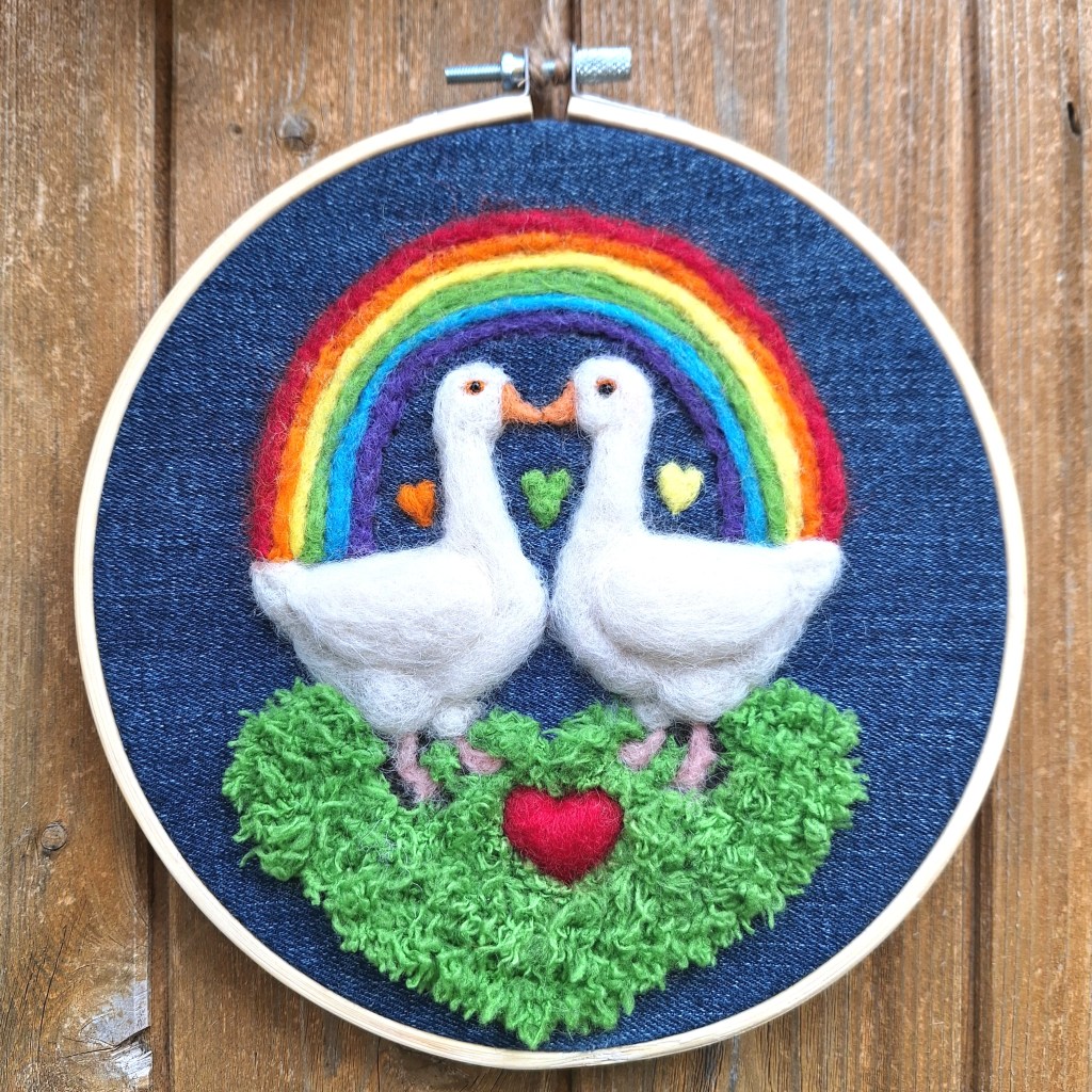 Two needle-felted geese under a rainbow (LGBT)